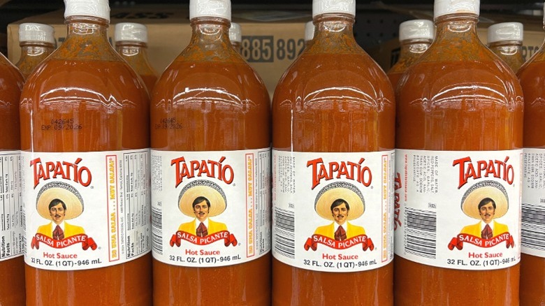 Bottles of Tapatío Hot Sauce on a supermarket shelf.