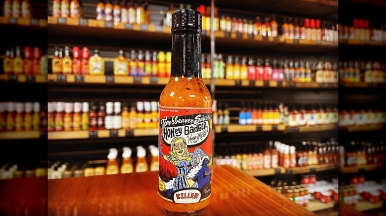 A bottle of Torchbearer Honey Badger Hot Sauce.