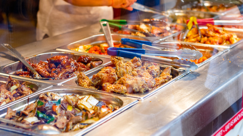 Close up of steaming trays of food at a Chinese buffet