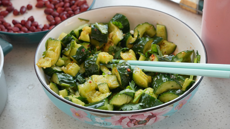 A bowl of cucumber salad with roasted peanuts