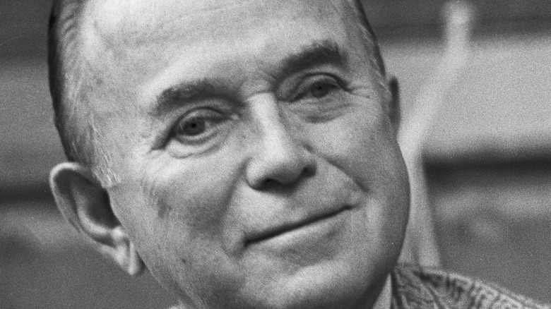 Close up of Ray Kroc smirking in black and white photograph