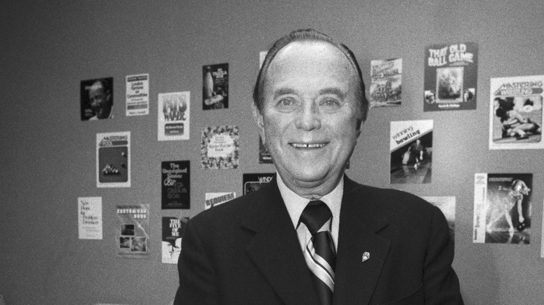 Ray Kroc smiling inside a McDonald's in black and white photograph