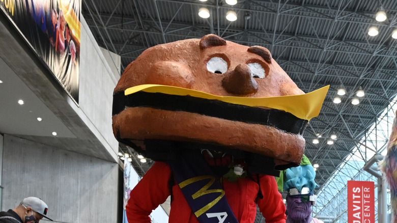 person dressed as Mayor McCheese in spacious convention center
