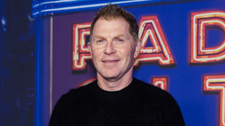 Bobby Flay wearing a black sweater at a public event