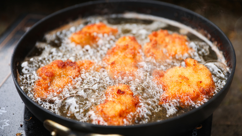 fried chicken pieces in oil