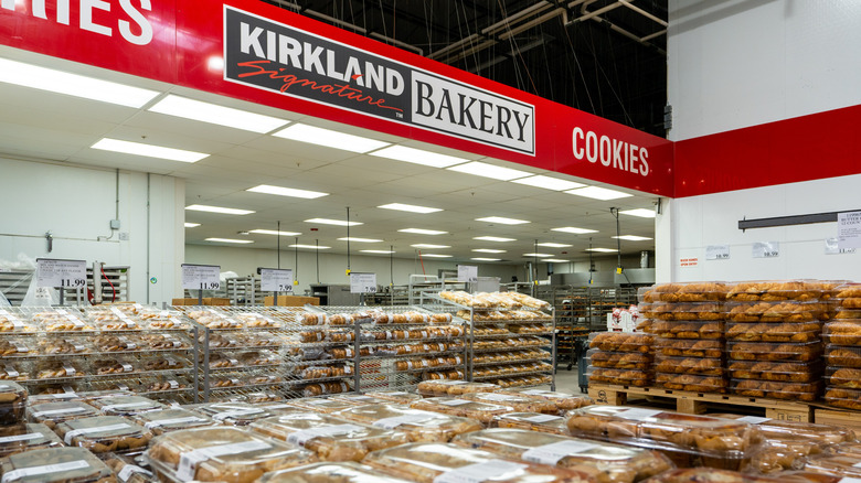 Costco bakery with shelves and rolling carts filled with various types of breads