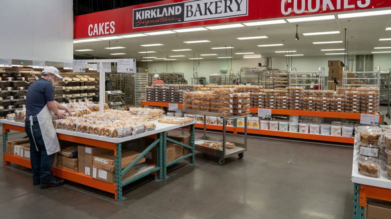 A Costco employee stocks the bakery section in the store