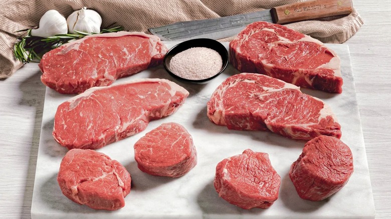 Contents of Rastelli's Antibiotic-free Grass-fed Angus Steak Box on white cutting board