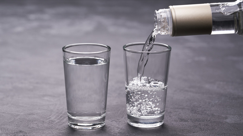 Pouring vodka into shot glasses