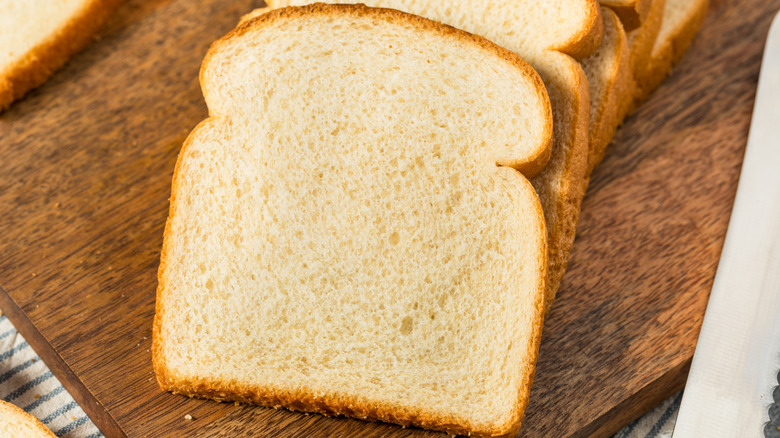 Sliced white bread on cutting board