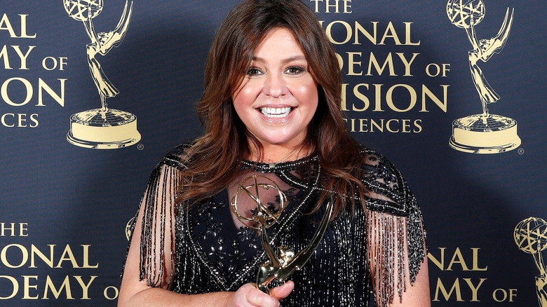 Rachael Ray smiling and holding an Emmy statue