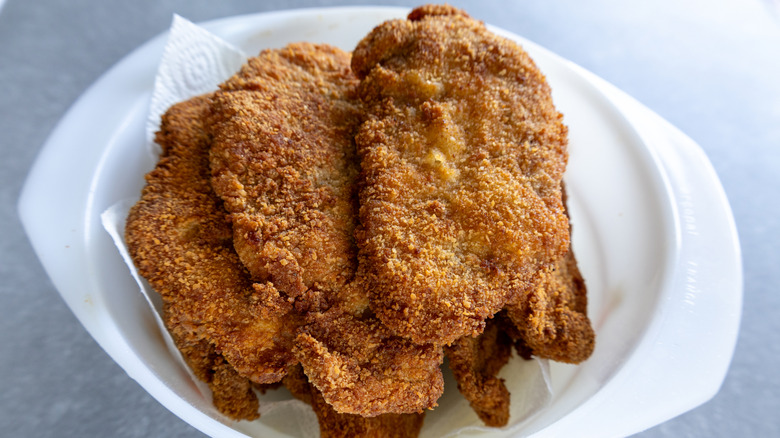Schnitzel served on a white plate.