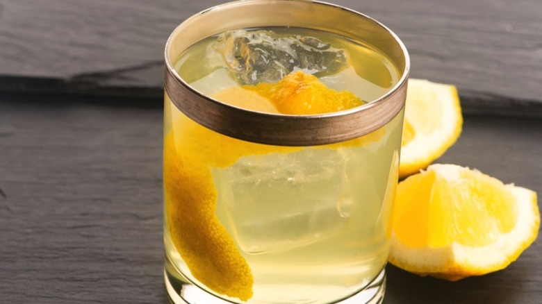 Clarified milk punch with ice and lemon.