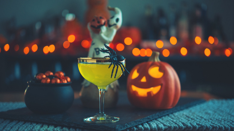 A Halloween cocktail with spider garnish