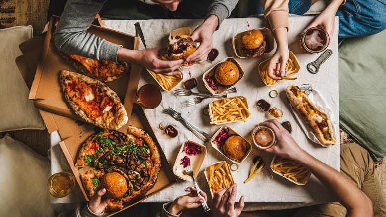 Top down view of people eating fast food items.
