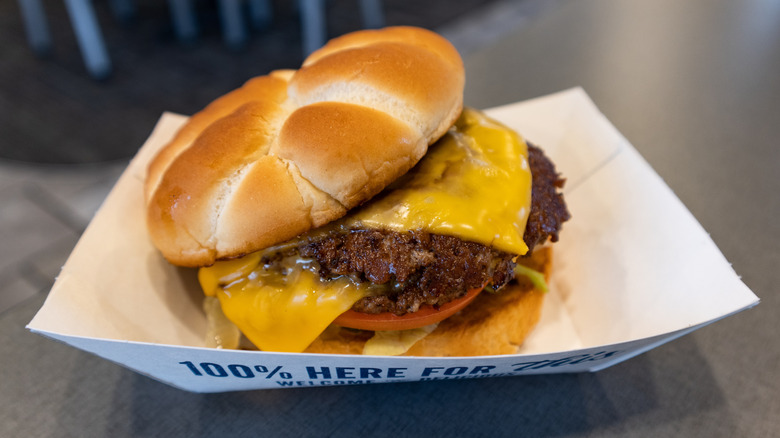 A cheeseburger on a butter bun from Culver's sitting in a paper tray.