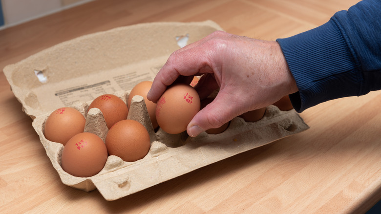 Taking an egg out of the box
