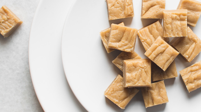 Cubes of peanut butter fudge on a white plate