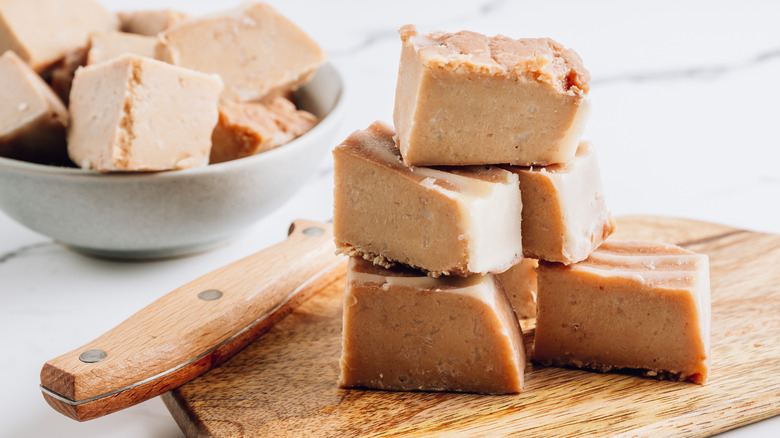 Pieces of peanut butter fudge on a cutting board