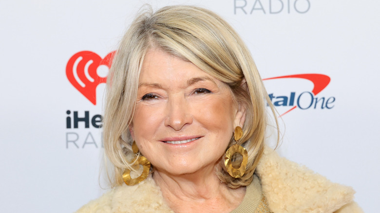 Martha Stewart wearing gold earrings, smiling