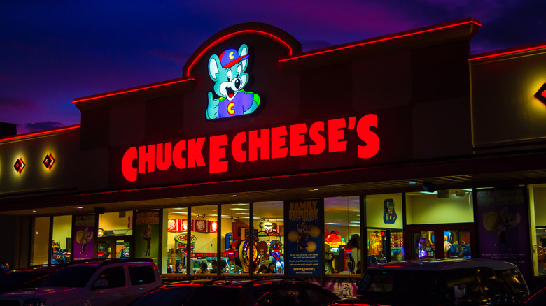 The exterior of a Chuck E. Cheese's, lit up at night