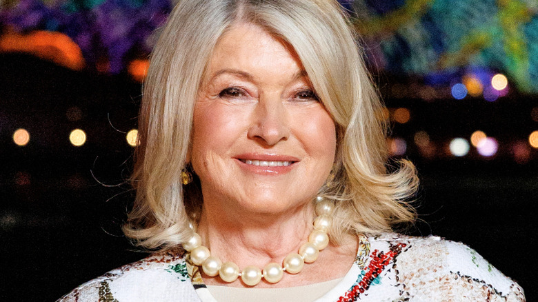 Martha Stewart smiles in a pearl necklace at an event