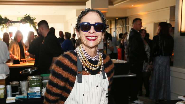 Nancy Silverton smiles in pearls and sunglasses at a food event
