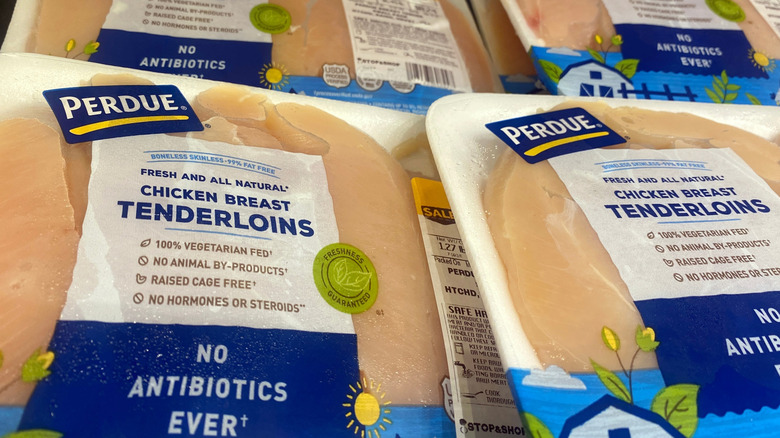Packages of Perdue chicken breast tenderloins in the refridgerated section of grocery store super market chain Stop and Shop.
