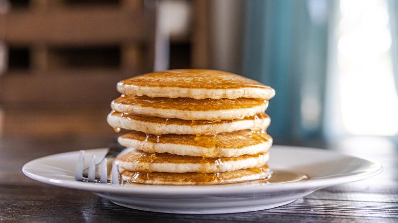 Stack of pancakes in syrup