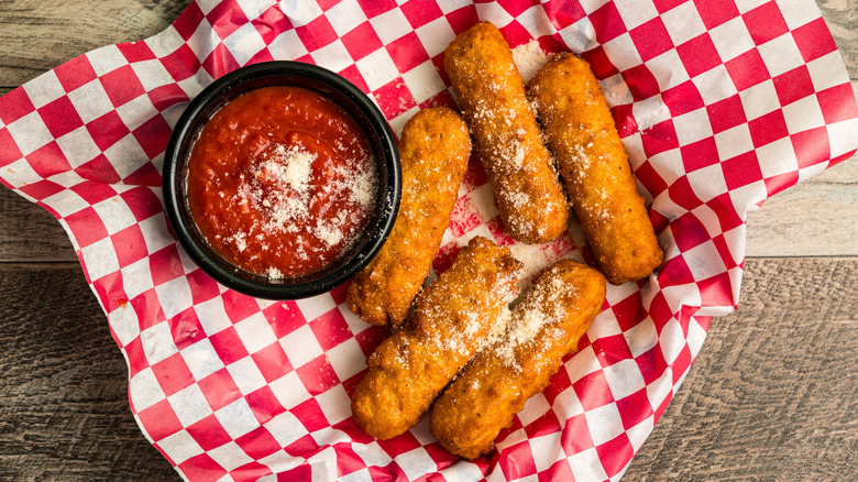 Top view of mozzarella sticks and side of marinara sauce