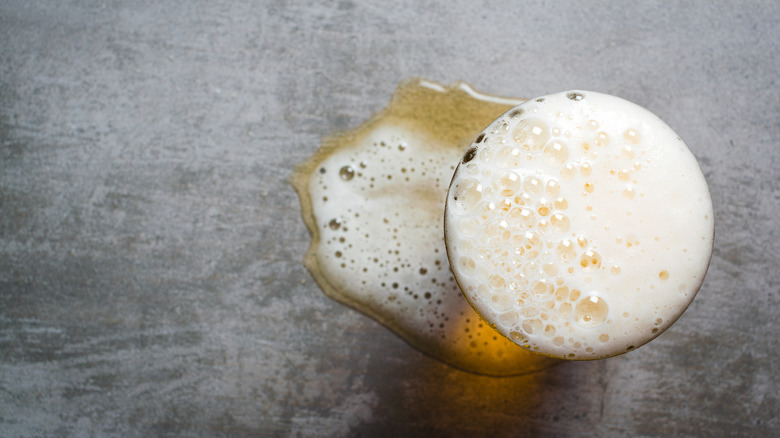 Beer with foam spilling over