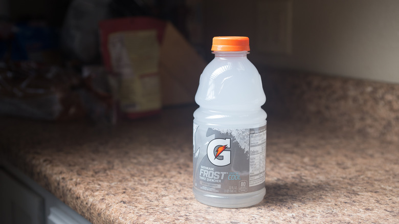 A bottle of Gatorade Frost Glacier Cherry placed on a kitchen counter