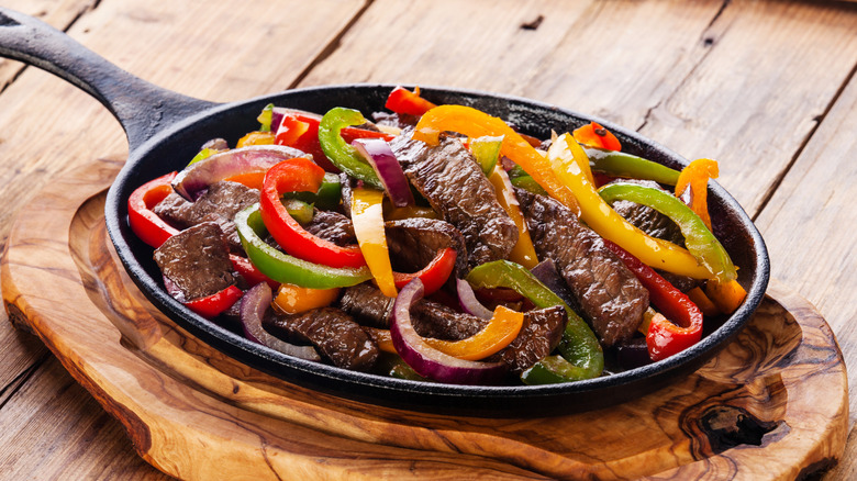 Platter of steak and bell pepper fajitas