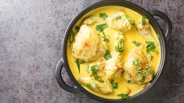 Top view of kuku paka East African chicken and coconut milk curry in a pot