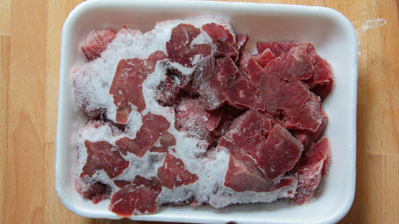 Frozen meat in a white ceramic dish