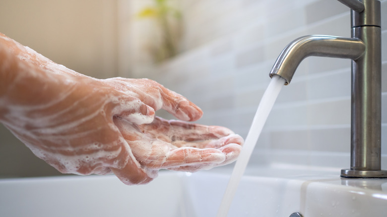 Someone washing their hands at a sink