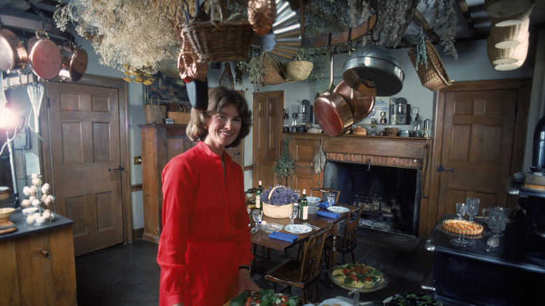Martha Stewart smiles in her 1970s kitchen with hanging pots on display