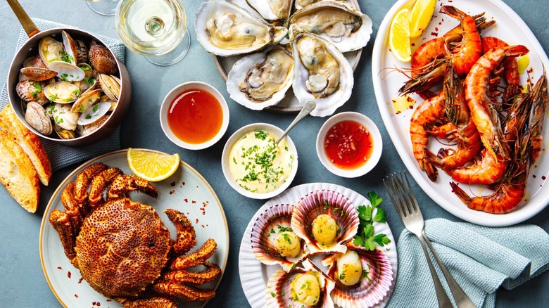 An assortment of seafood dishes with sauces on a table