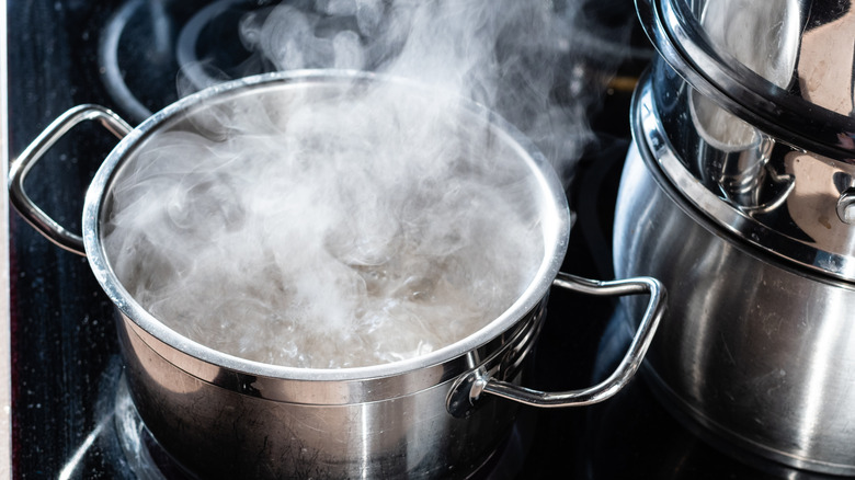 A boiling pot on a stove.