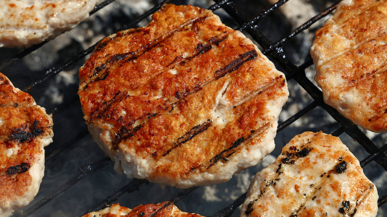 Turkey burgers cooking on a grill