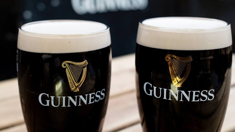 Two pints of Guinness, with the heraldic harp prominently displayed.