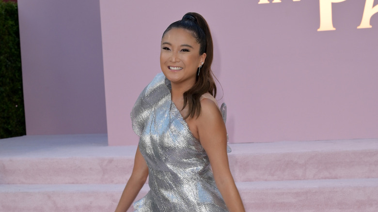 Ashley Park in one shoulder silver dress