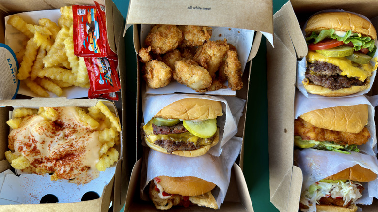 A variety of Shake Shack burgers, fries, chicken sandwiches, and chicken nuggets