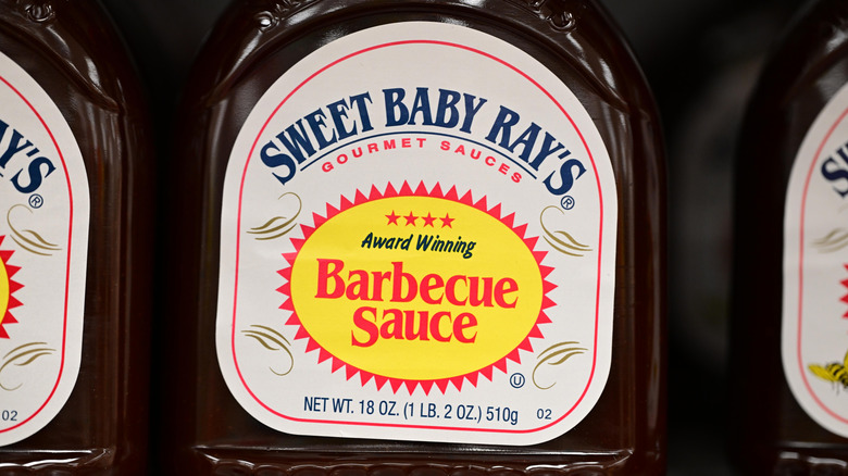 A closeup shot of a Sweet Baby Ray's bottle on a store shelf.