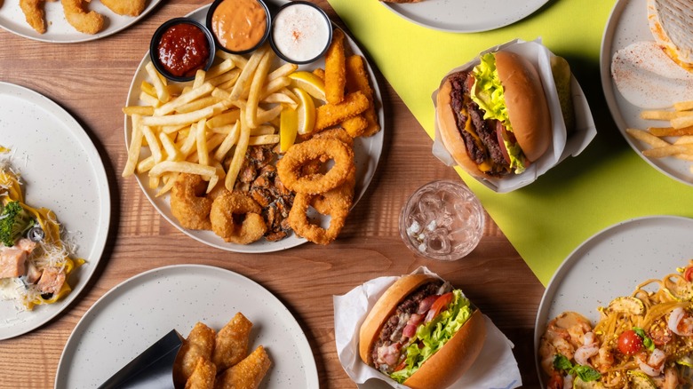 Top view of mltiple fast food items on wood table