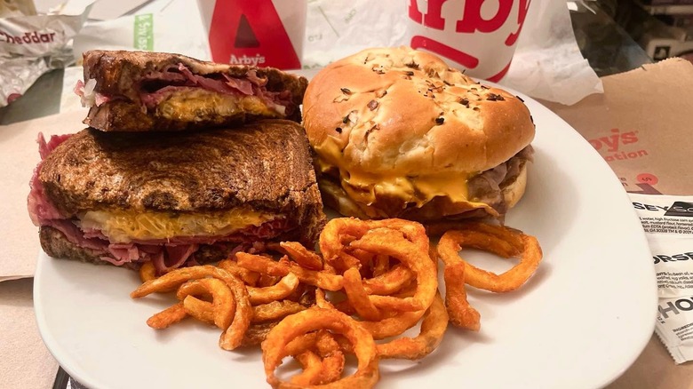 Arby's sandwiches and curly fries on white plate