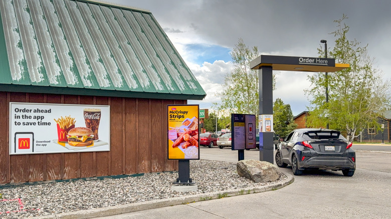 A car sitting in the drive-thru at a McDonald's location