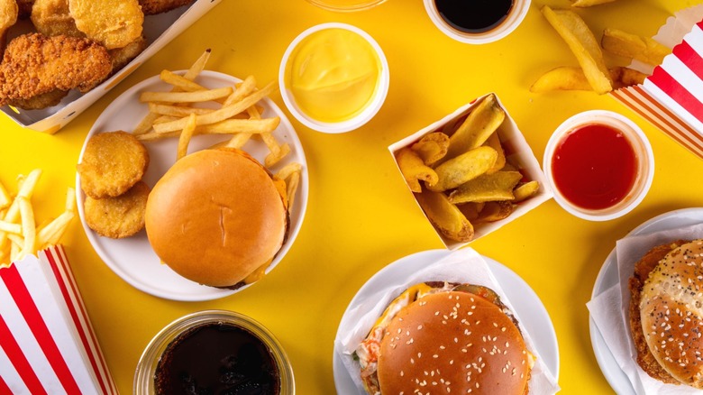 An assortment of fast food items on a yellow background.