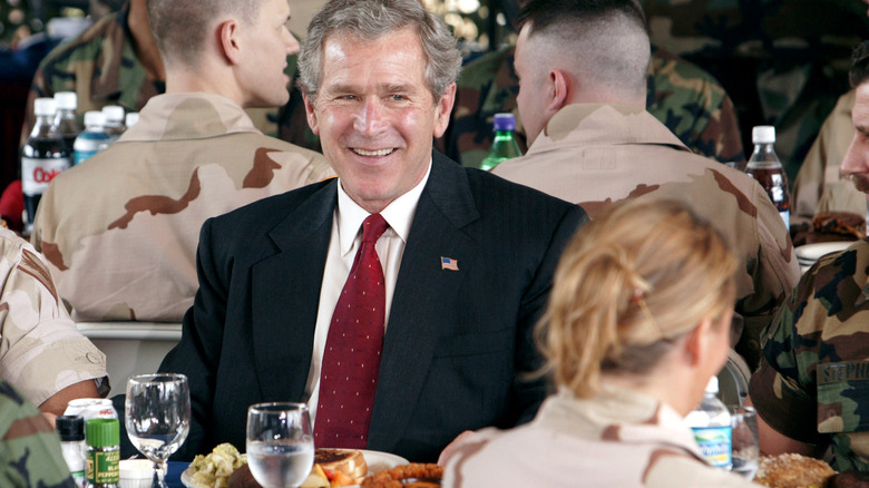 George W. Bush at a table with food and drink
