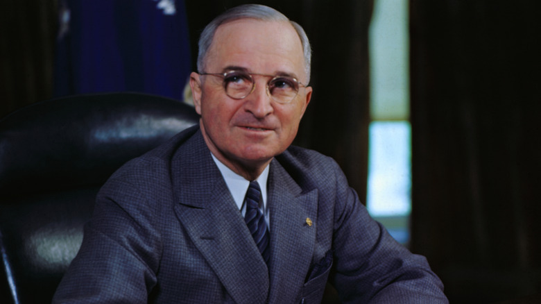 Portrait of President Harry S. Truman smiling at his desk